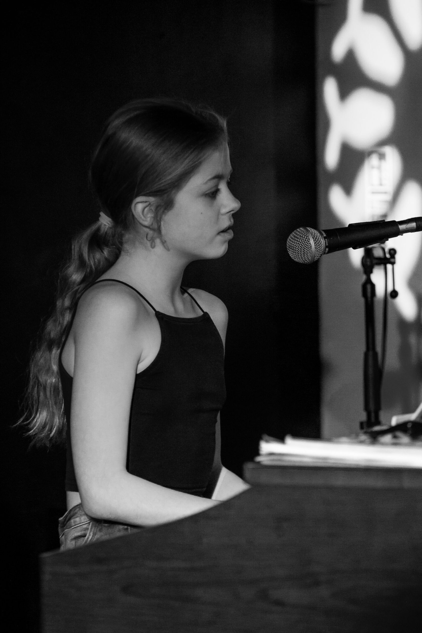Pocket money performer Libby Ray singing and playing piano